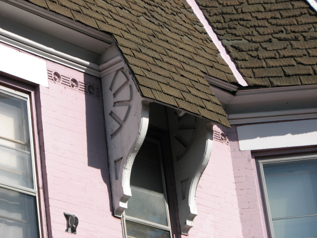  Incised brackets adorn upper windows of a few homes.