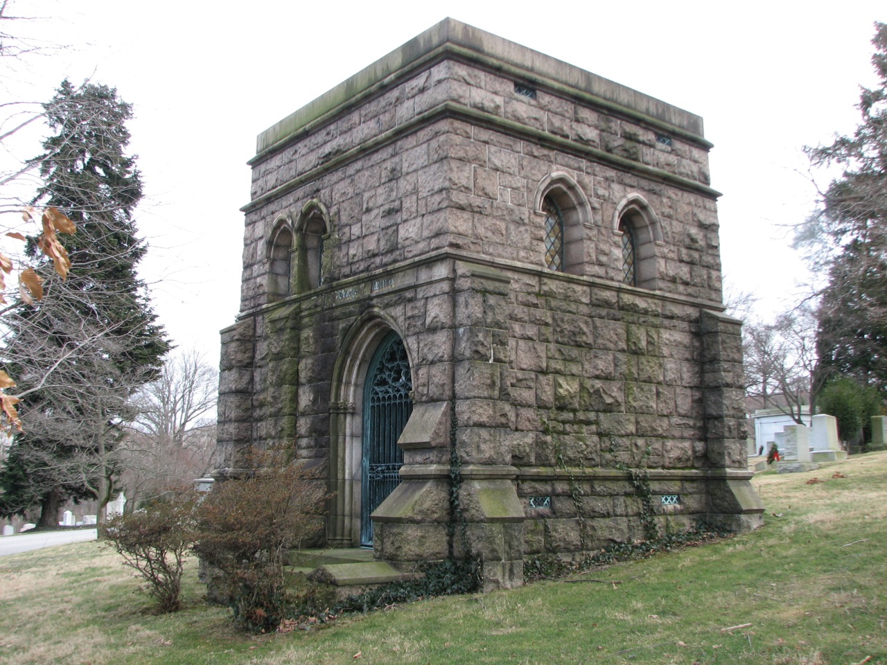 A tomb of rough-hewn stone resembles a Gothic castle.