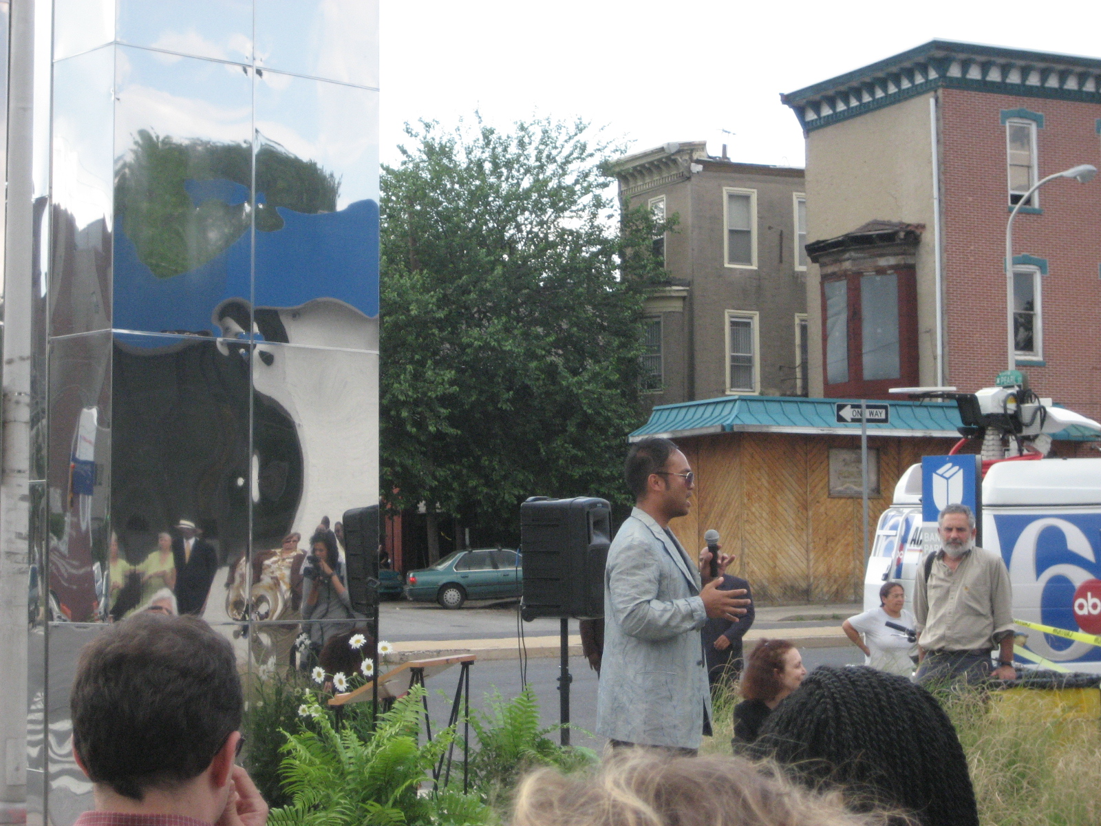 Artist Jeffrey Manuel explains to neighbors in Powelton Village the creative process behind the new sculpture.