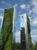 Artist JEFRE's RE:flect sculpture at 38th and Powelton features reflective sides and natural plant bedding.