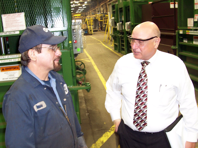 Garry Fadula, Vice President of Operations at PTR Baler & Compactor Co., talks with a longtime co-worker.