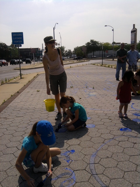 Denise Lopez and daughters Carly and Chloe painting the creek