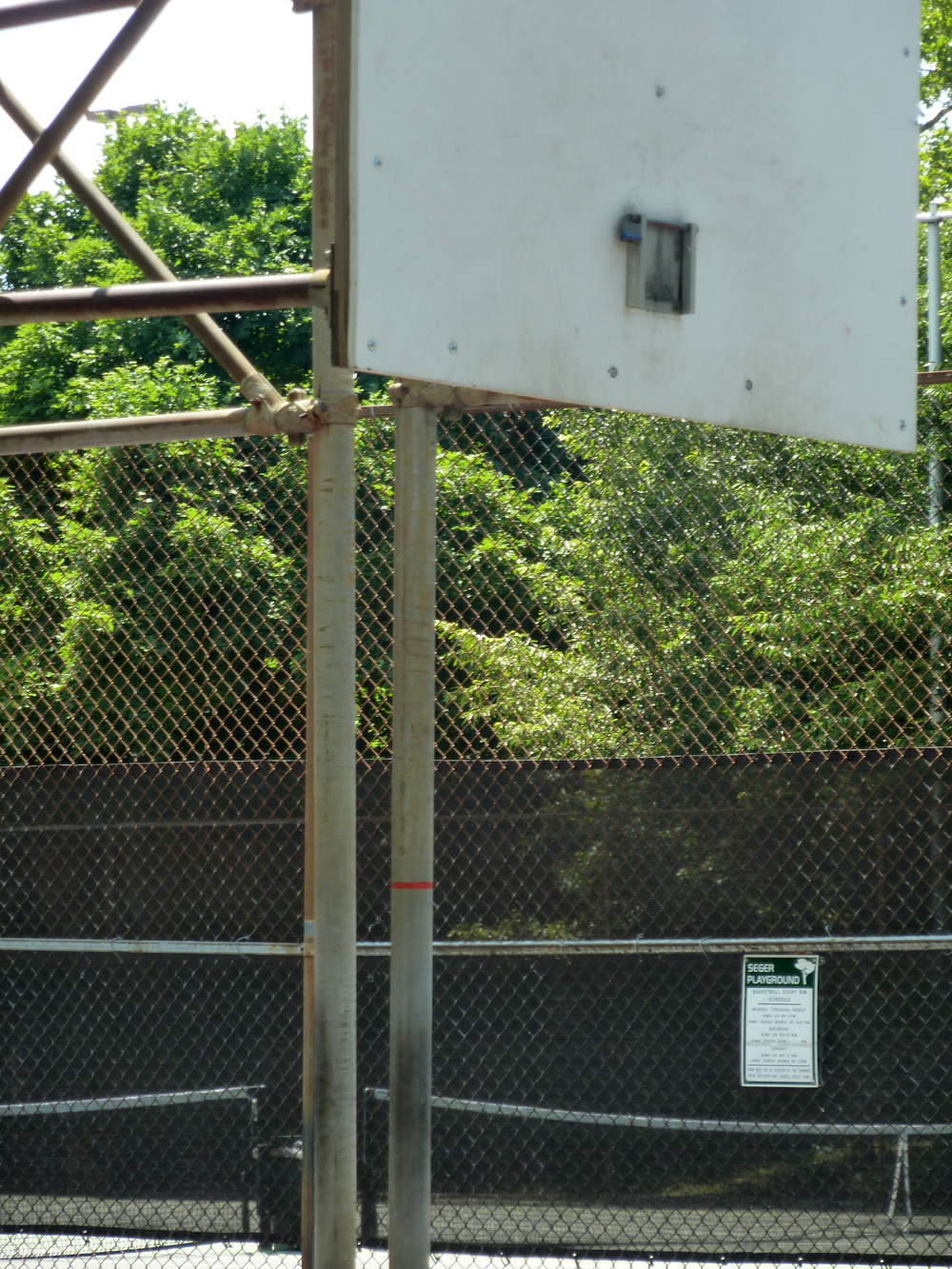 A basketball backboard lacks a rim in a Philadelphia park.