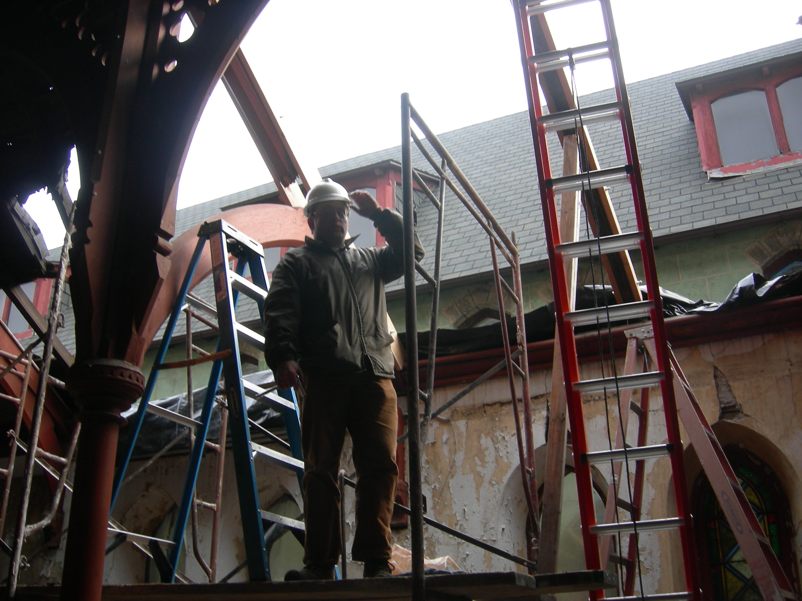 Aaron Wunsch, professor in PennDesign's historic preservation program, on scaffolding during roof repairs. | photo by Melissa Jest, Preservation Alliance for Greater Philadelphia