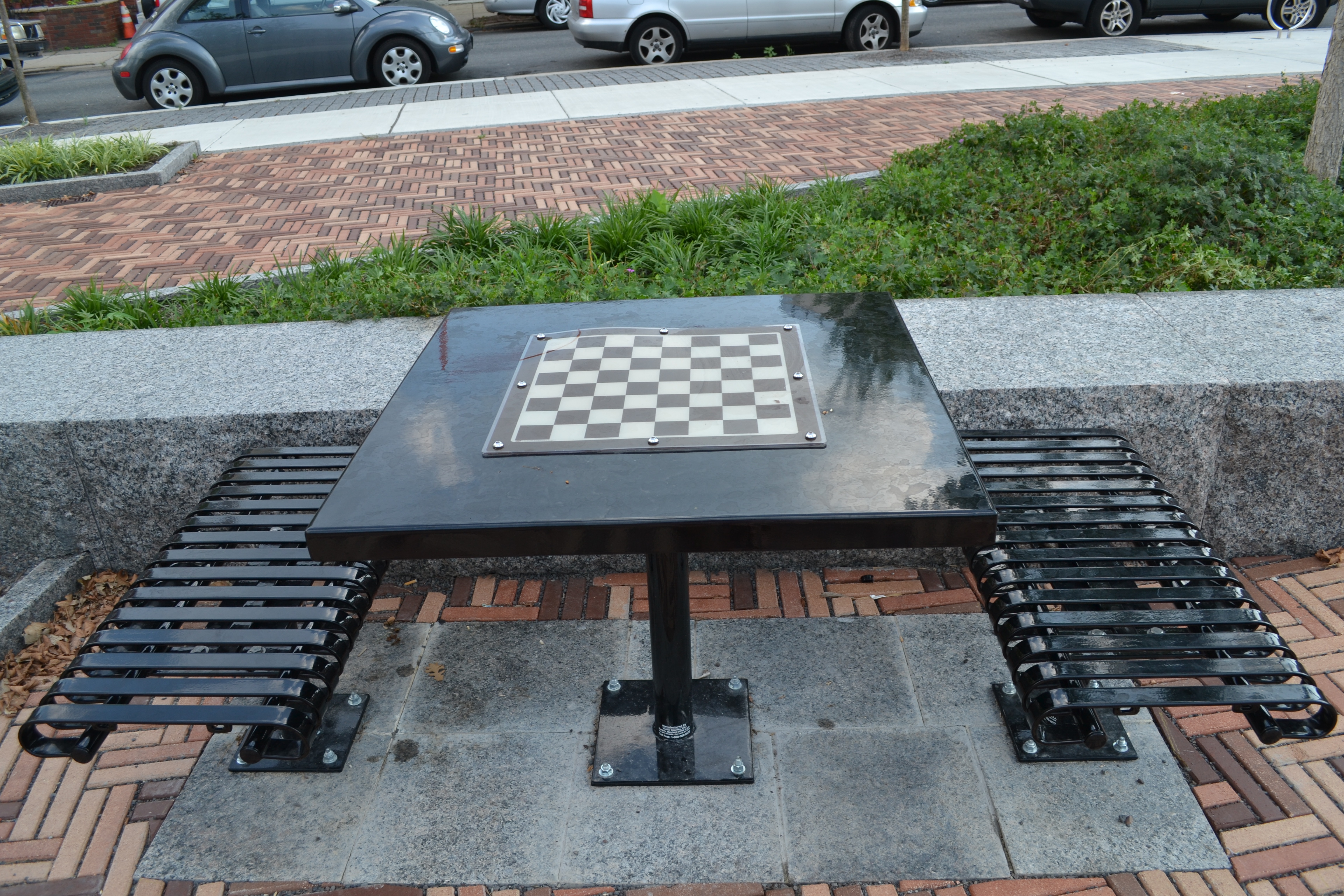 A chess table is tucked away on the south edge of the park