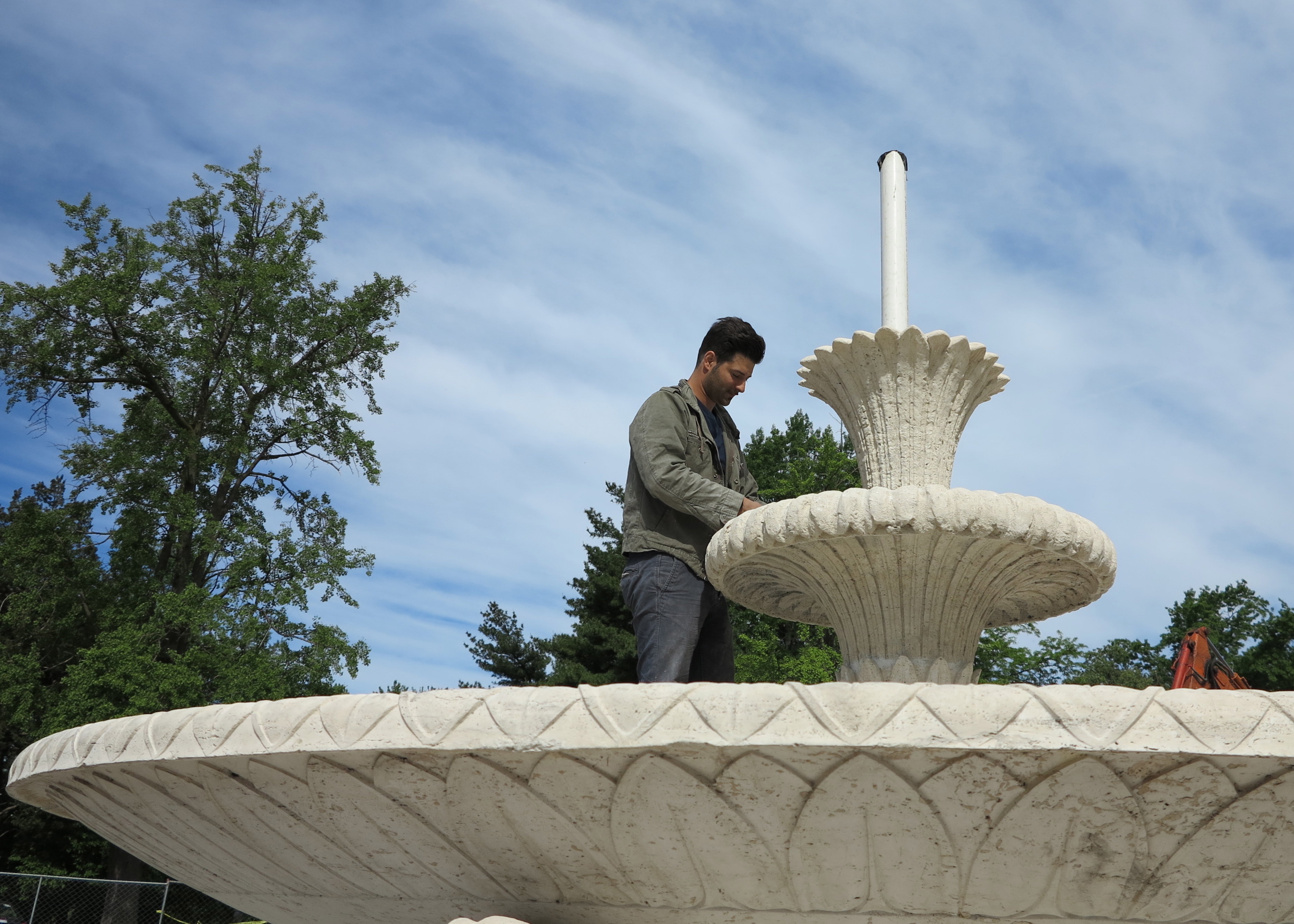 Conservator Marco Federico in fountain's shallow bowl.