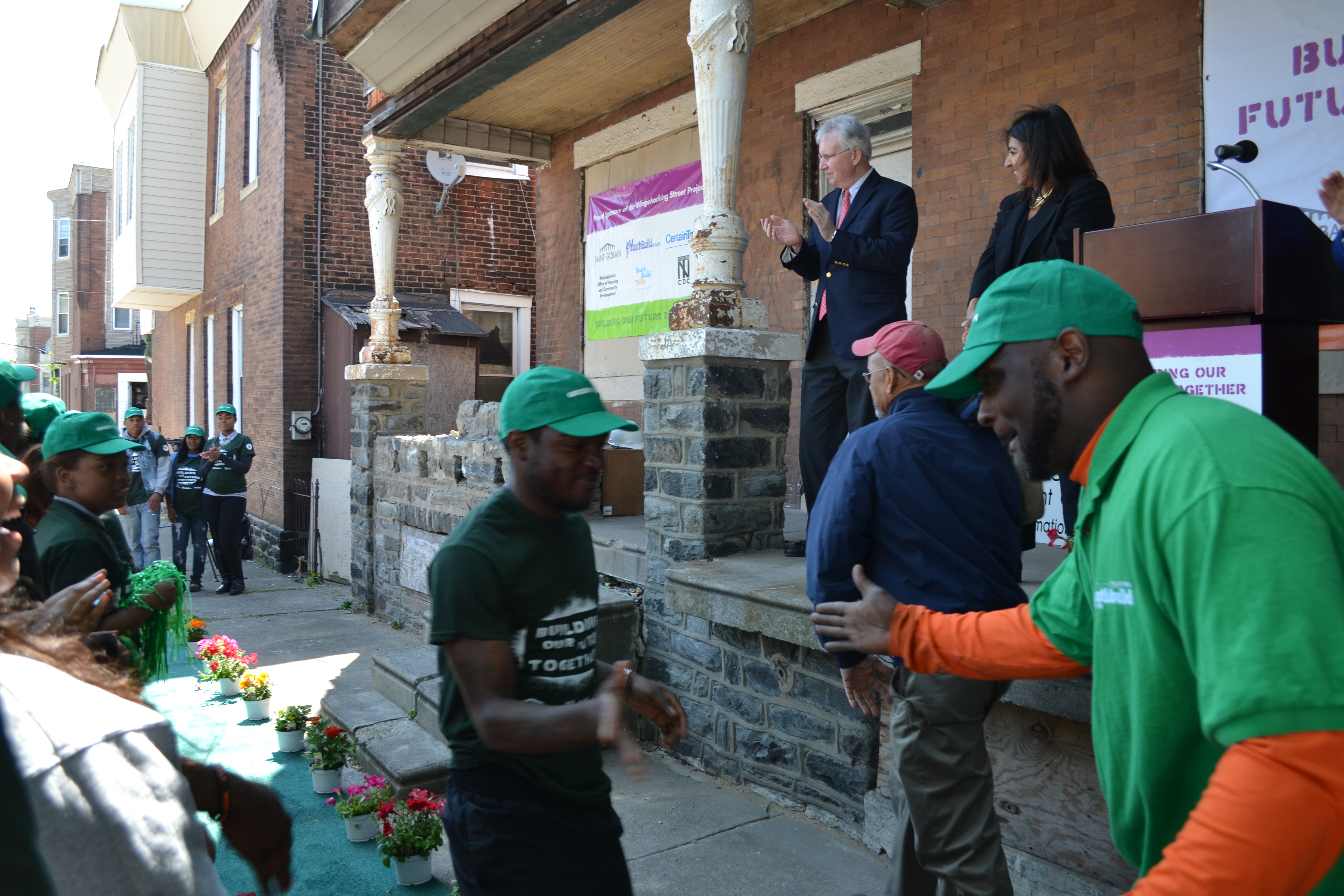 YouthBuild Philadelphia students ran down a green carpet at the groundbreaking 