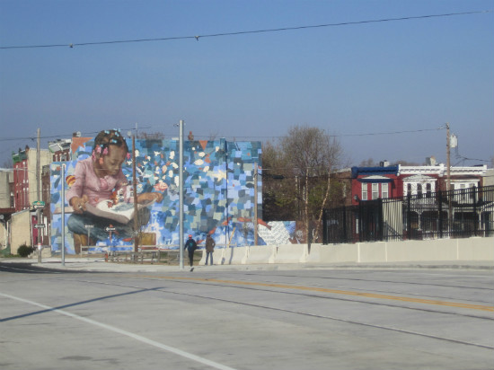 A large mural greets people crossing the bridge into East Parkside.