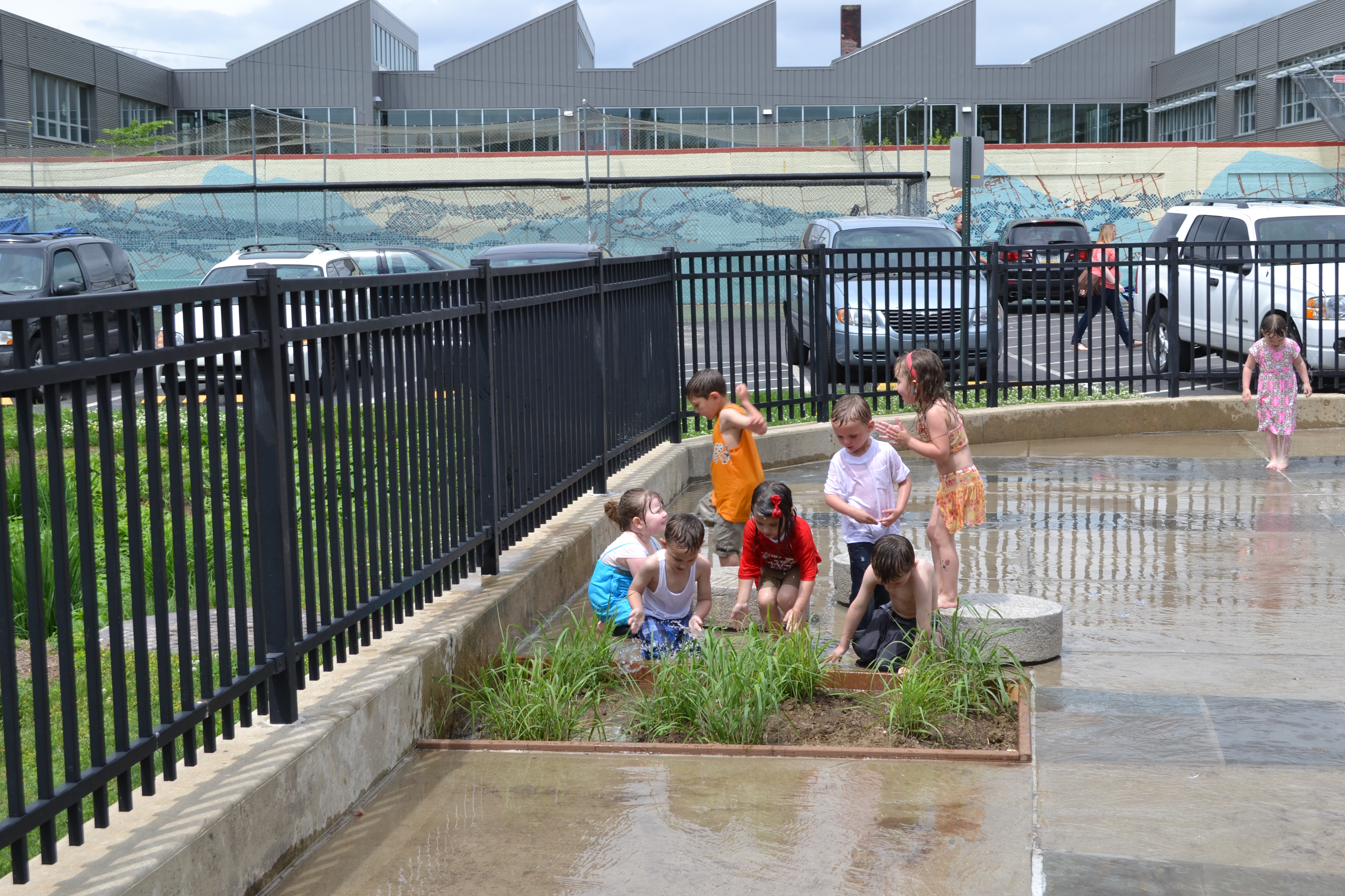 Kids splashed in the new Shissler Rec Center sprayground plant feature