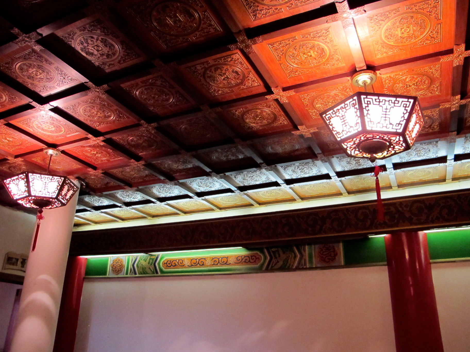 Lanterns, coffered ceiling, and painted wood panels.