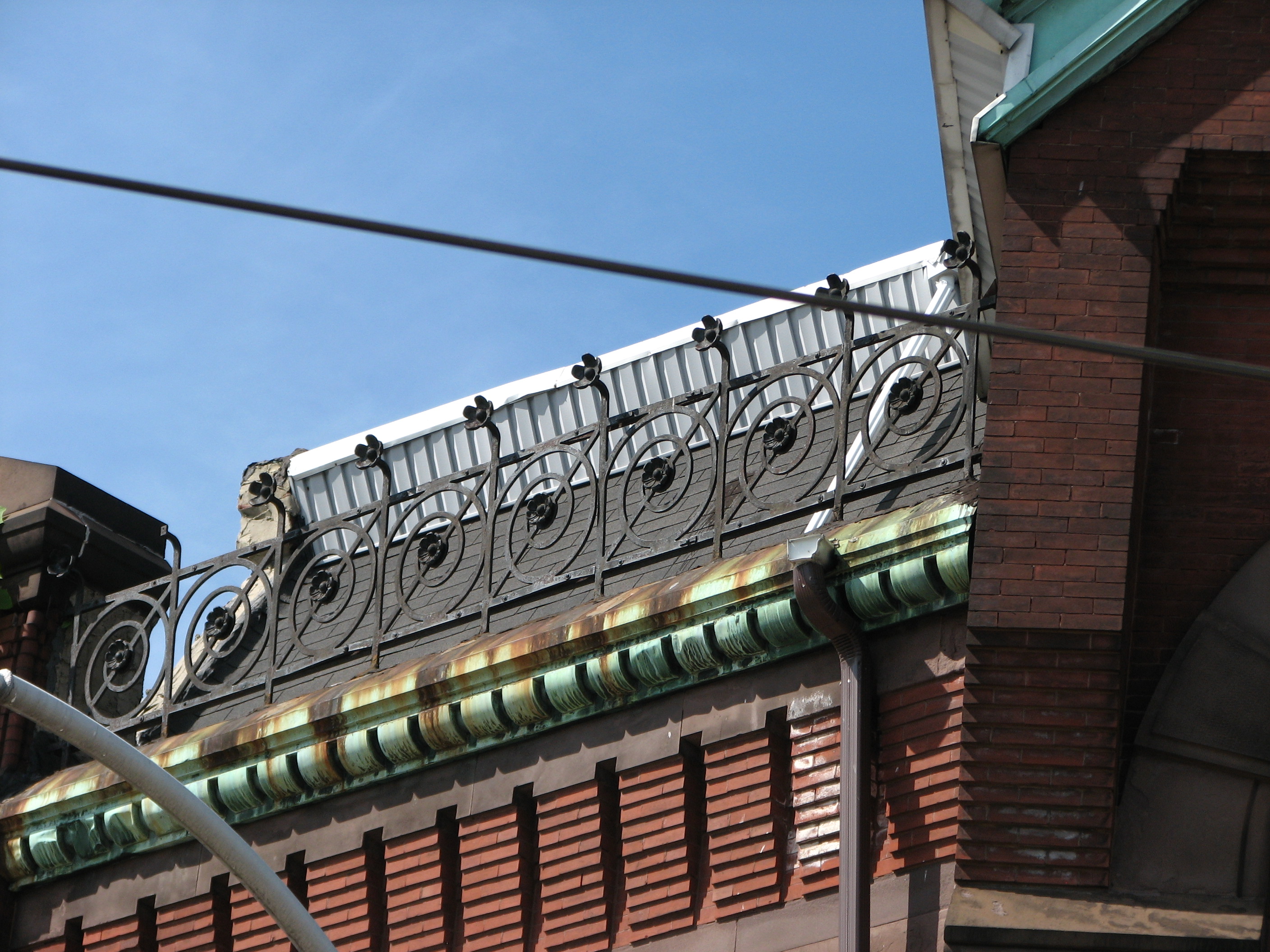 The elaborate ironwork along the roofline, as well as many other features, recall the work of Frank Furness. 