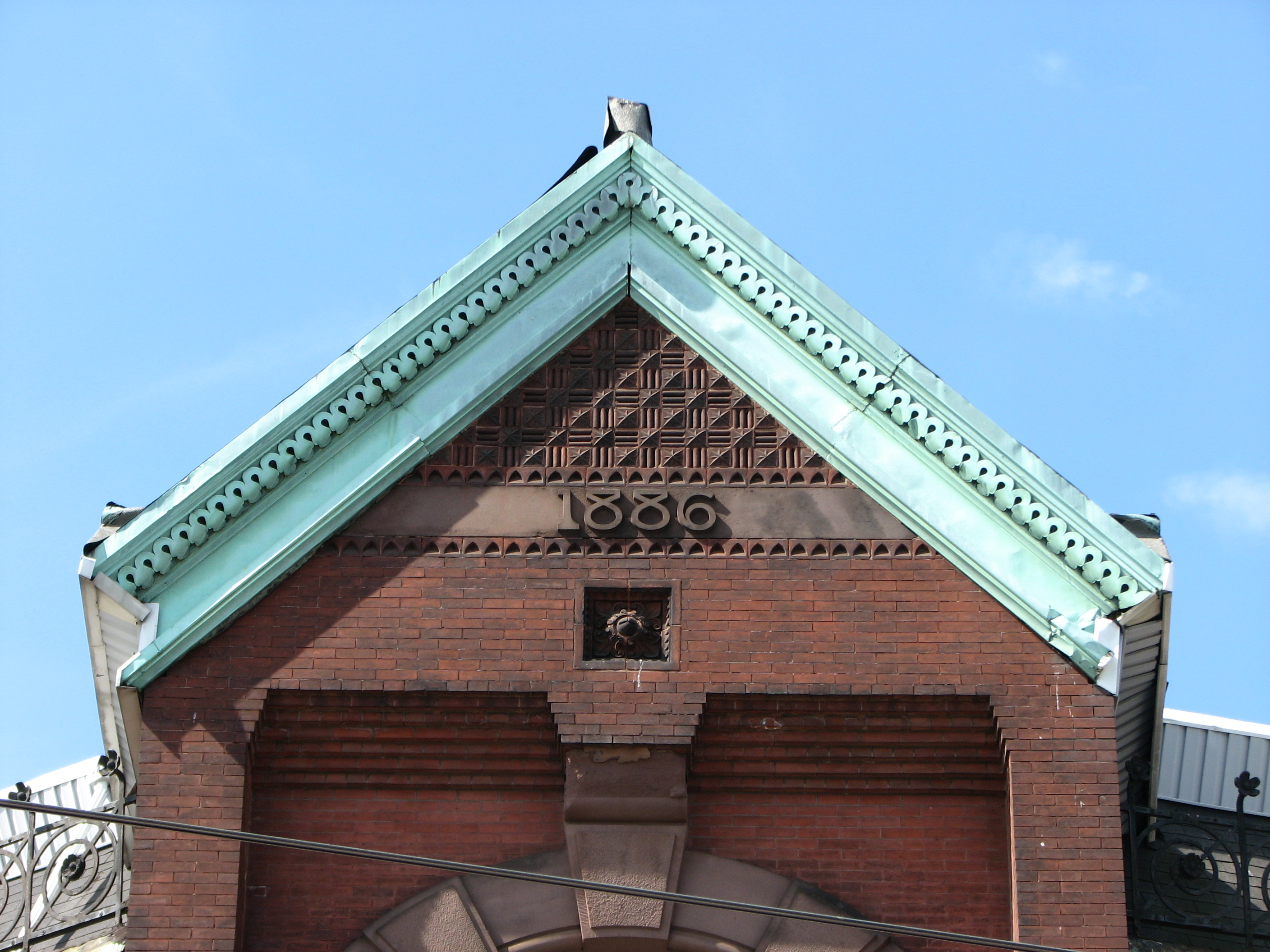 The gable at the top of the building announces the year of its birth.