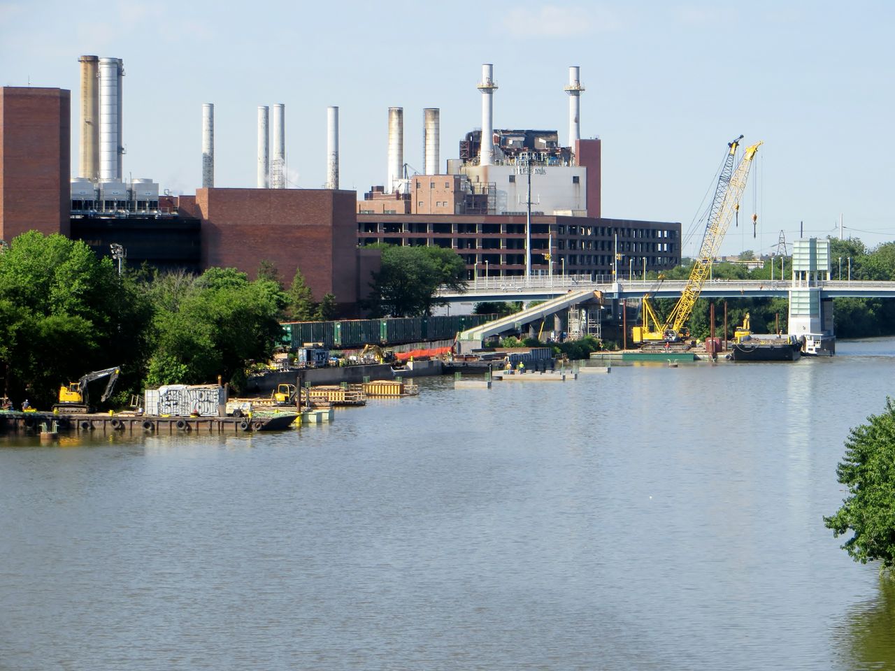 Phases of construction and equipment span the Schuylkill's banks