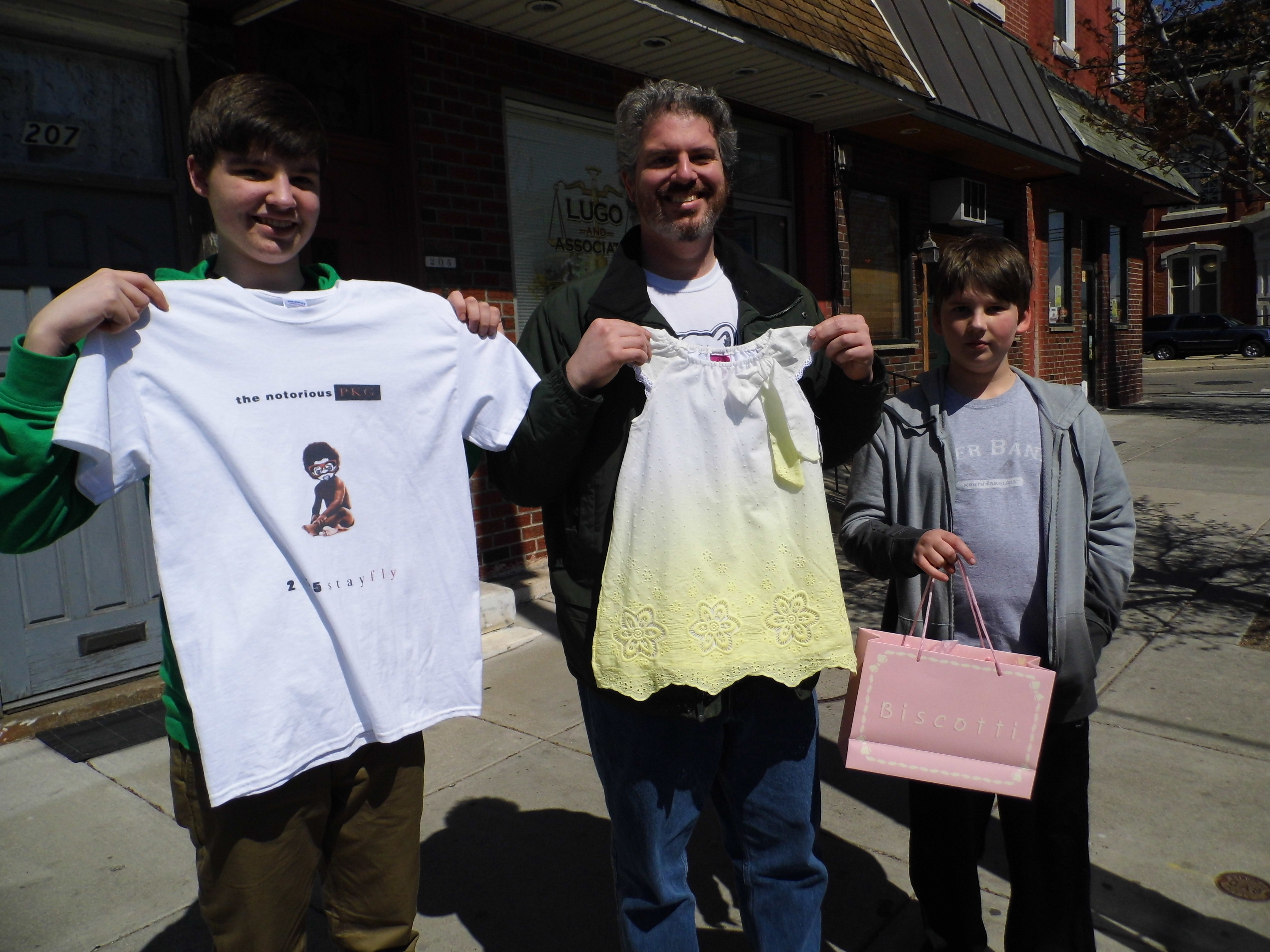 Resident Dan Abrams and sons Ben, 15, and Nathaniel,11, spent their Equal Dollars at Philly Kid Grafix, Kiddie Kouture and George’s Pizza