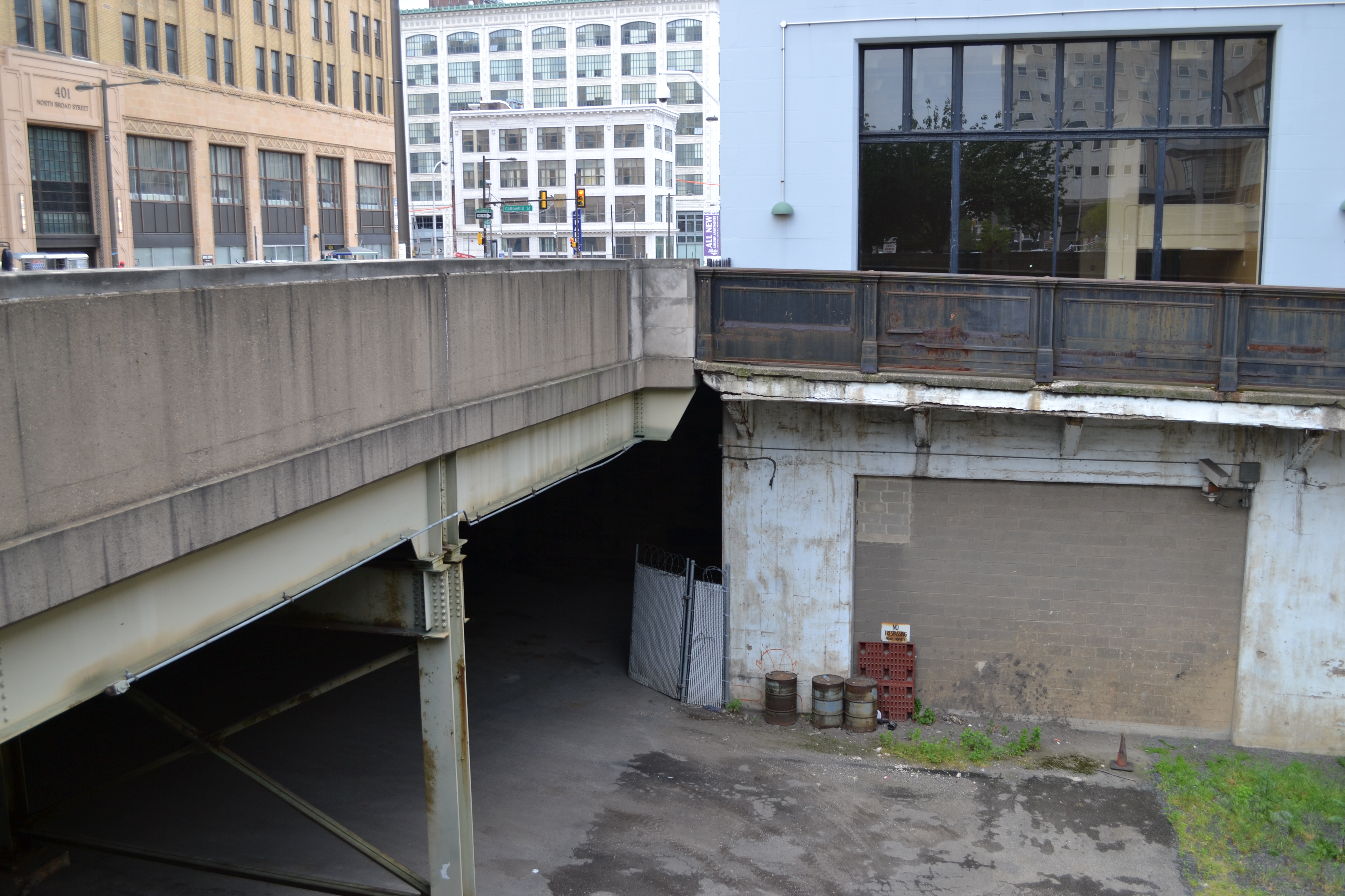 The bridge is visible through a small opening next to the former Inquirer building