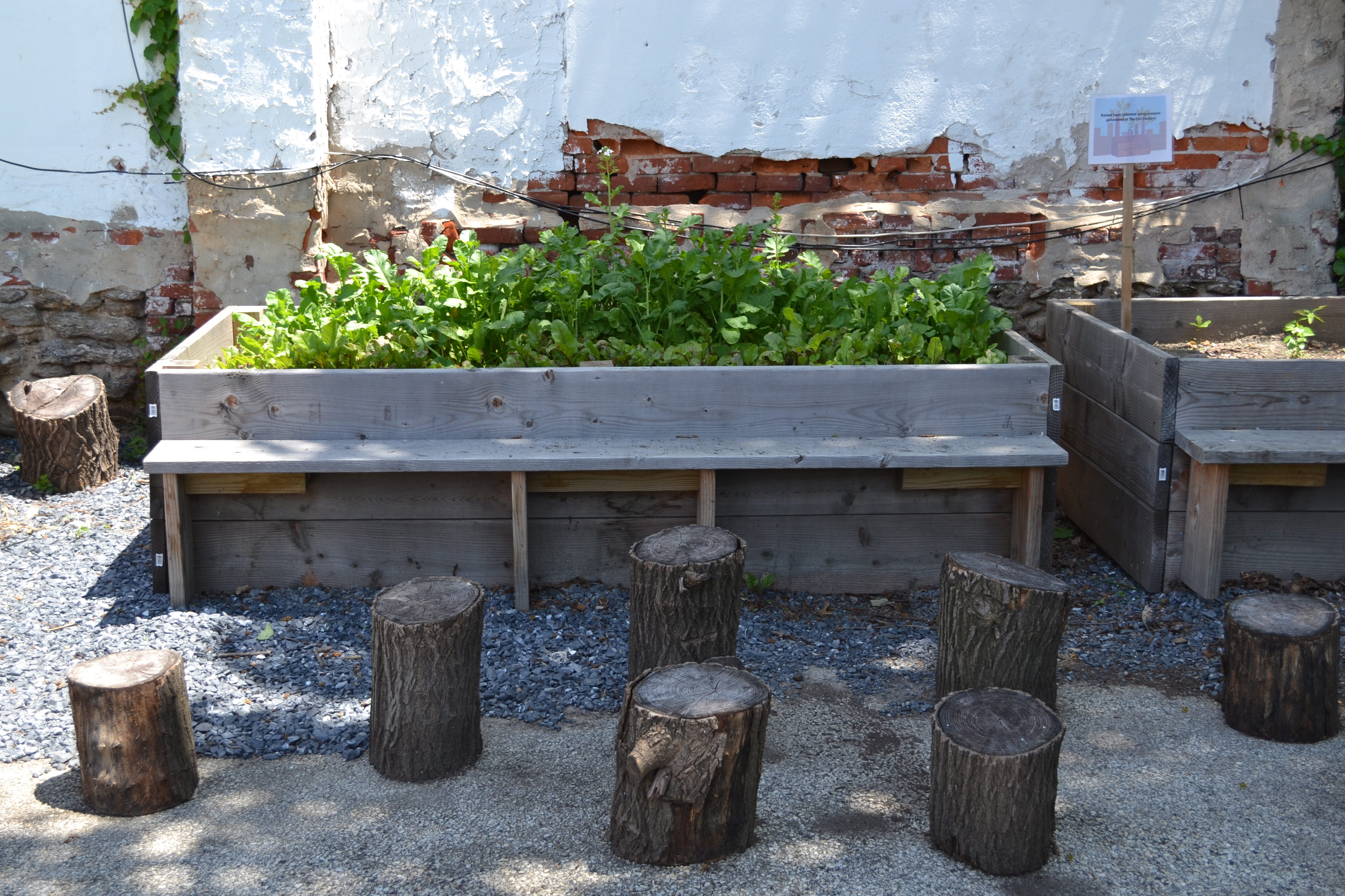 With recycled stump seating and vegetable beds, The Dirt Factory also serves as a community space 