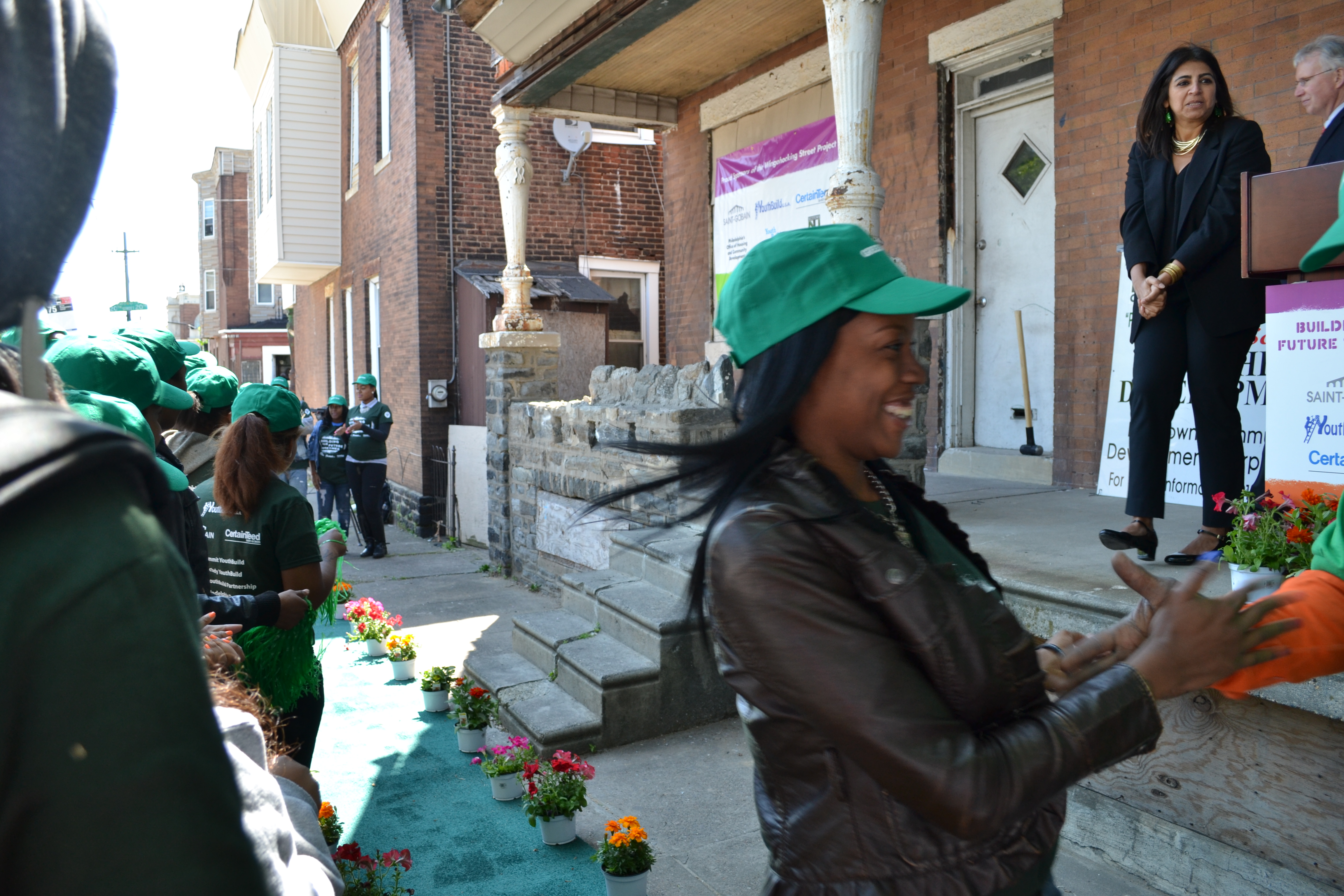 YouthBuild Philadelphia students ran down a green carpet at the groundbreaking 