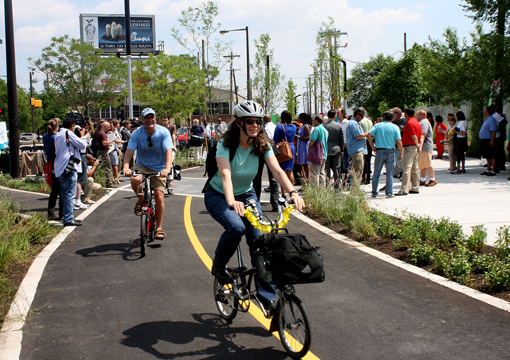 Bikers ride along stormwater tree trenches on Penn Street Trail