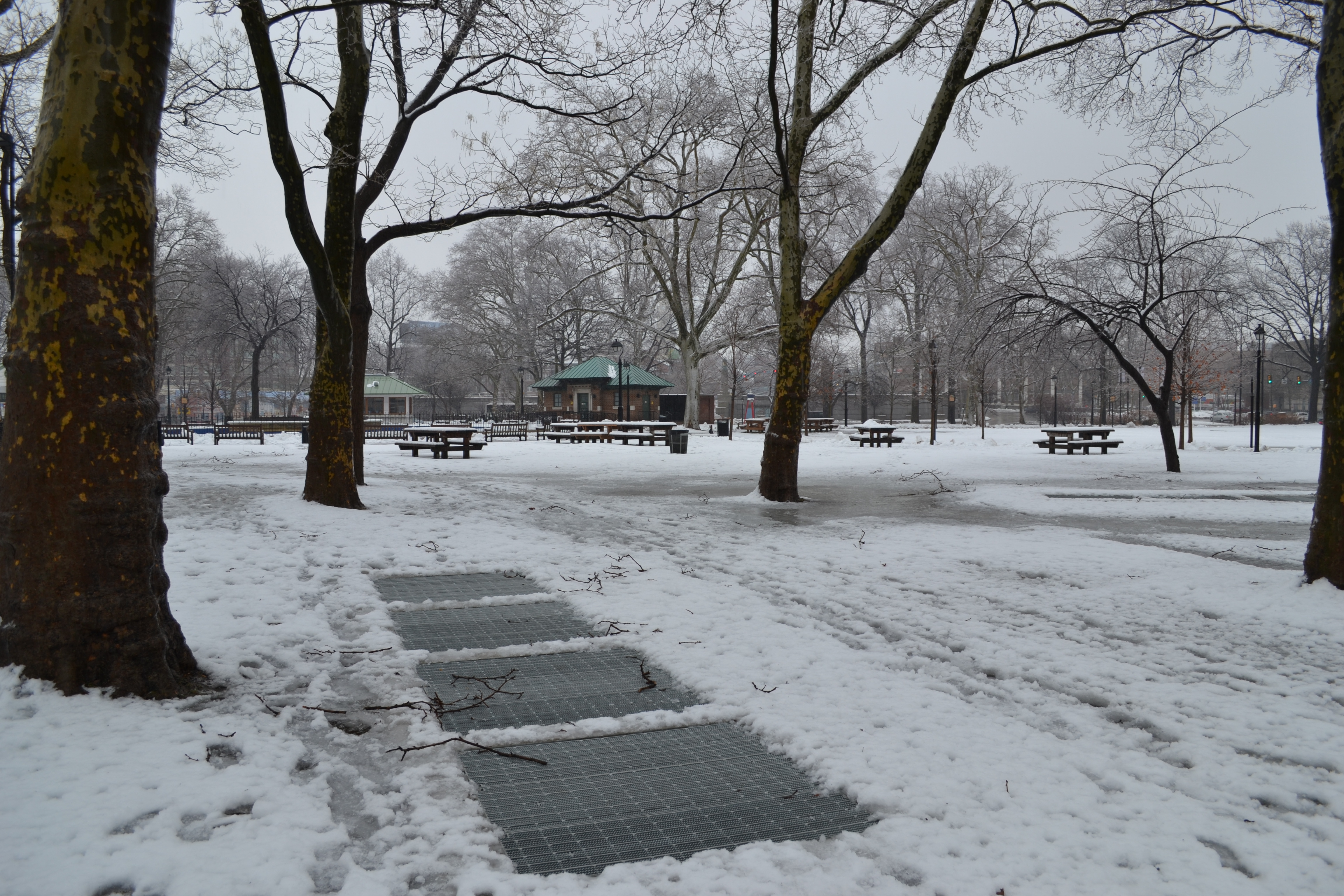 Even in the snow, subway grates betray the station's hiding space beneath the park