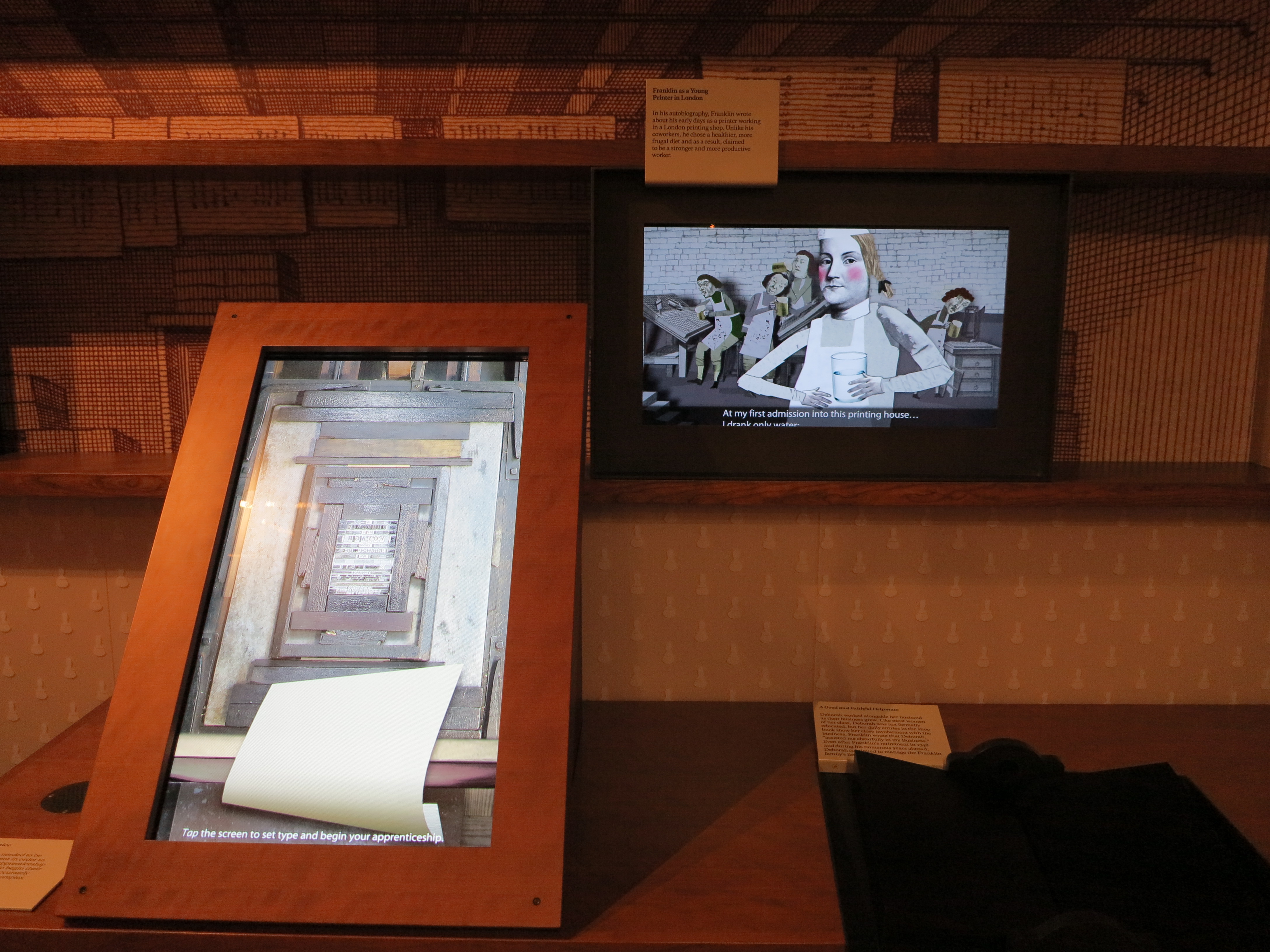Interactive and video displays about Franklin's background as a printer.