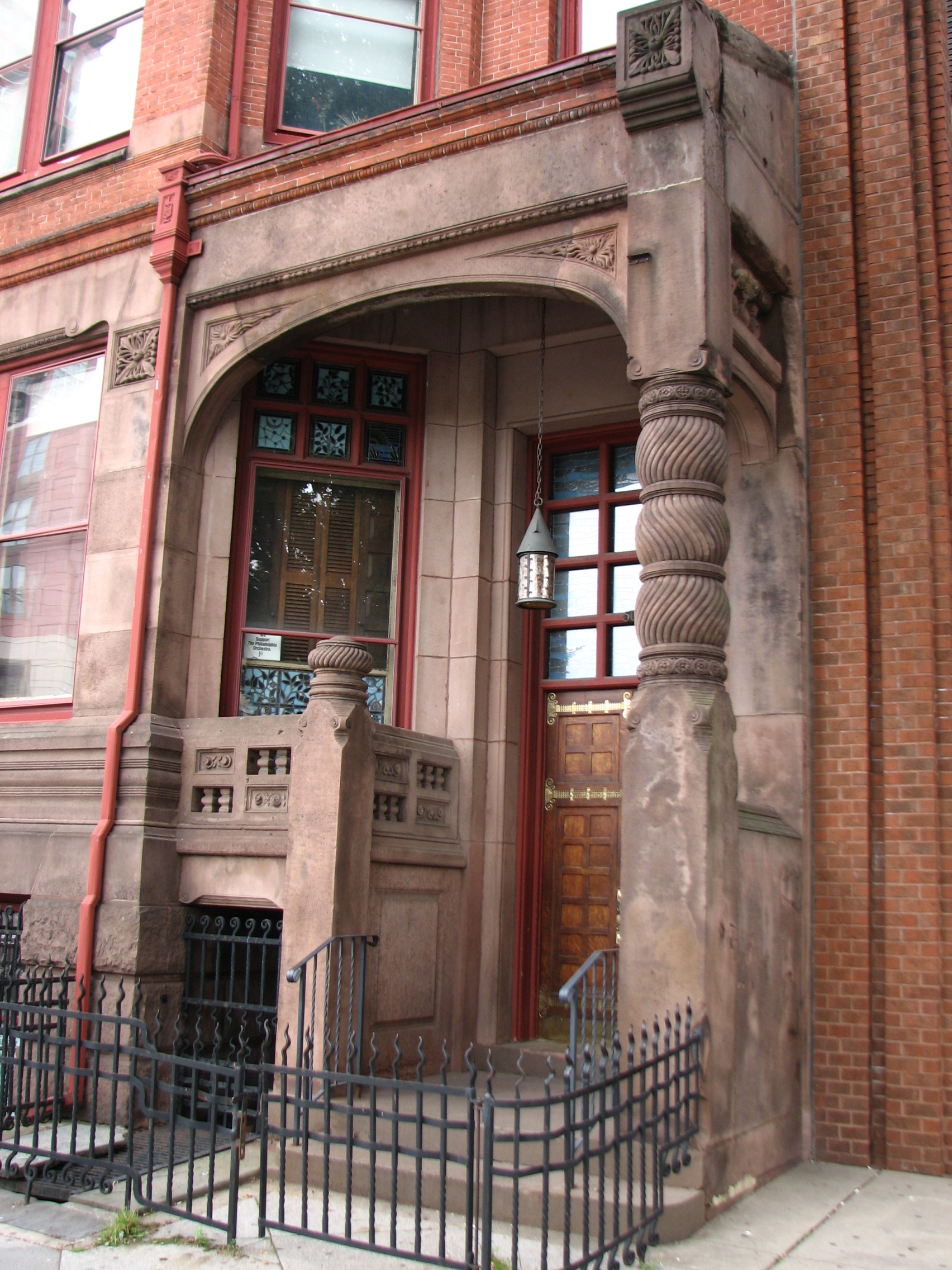 The entrance to the Lippincott House features elaborate ironwork and carved brownstone. 