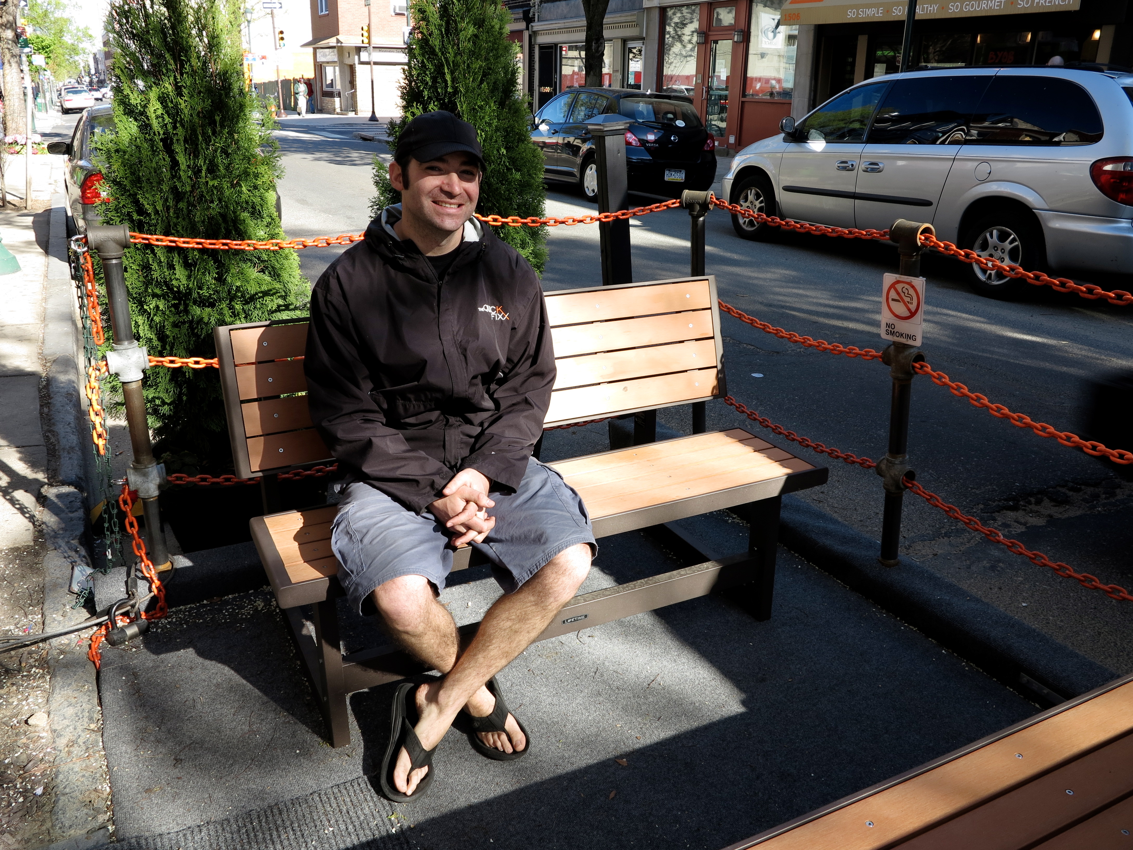 Matt Levinson, owner of The Quick Fixx giving the new parklet a test 