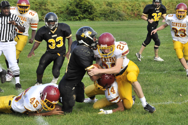 Receiving a key block by teammate Jon Gelin (32) (upper right), Lincoln's dependable running back/defensive back, Omar Black (9) was able to return a kickoff for 20-30 yards. A couple plays later 
