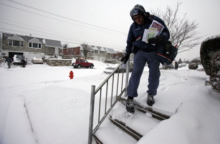Despite the nearly two feet of snow, mail carriers trudged on. AP photo taken in the Northeast.
