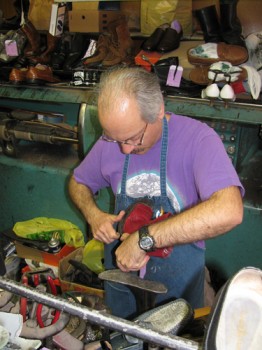 Eugene Oliveti, who says business is always ambient, fixes a pair of shoes in his Frankford shop.