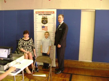 Sens. Tina Tartaglione and Mike Stack stand with second-grader Gabriel Ortiz as his photograph is taken.