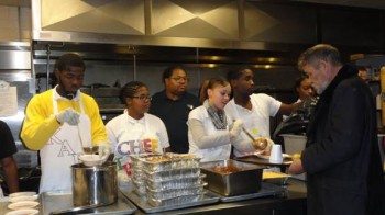 Students from Camelot Schools’ Excel Academy South serve the lunch that they prepared to homeless residents of St. John’s Hospice in Center City. Photo courtesy of Camelot Schools.