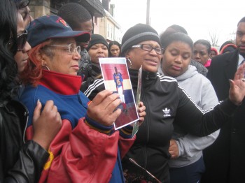Shirley Phelps-Pollard holds pictures of grandson Christopher Spence during his days playing football for Frankford High School. Spence's mother, Javese Phelps-Washington, (r) says she forgives th