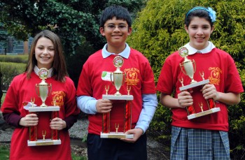 (L to R) 2nd Place Jamie Wurtenberg of St Albert the Great, 1st Place Adrain Toledo of St Jerome and 3rd Place Kerrianne Mullen of St Anselm took home Spelling Bee trophies. Photo by Archbishop Ryan H