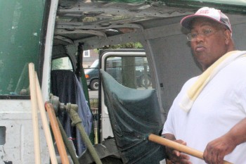Raymond Grant of Philadelphia Cares brings supplies to help clean Wilmot Park. Photo courtesy of the Frankford Gazette.