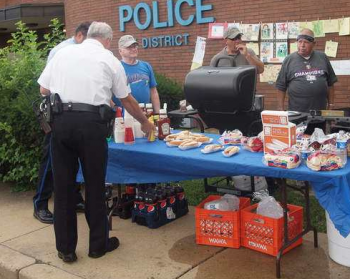 8th District residents and officers enjoyed a barbecue at the 2010 National Night Out event. Photo by Joe DiFlorio.