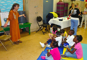 Michele Belluomini tells a story to children at the Northeast Celebration. Photo by George Mai