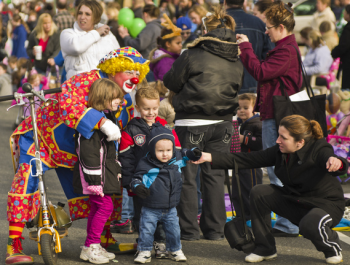 Families watch as the Mayfair-Homesburg Thanksgiving Parade rolls down Frankford Avenue in 2010. Photo by Brian Bailey.