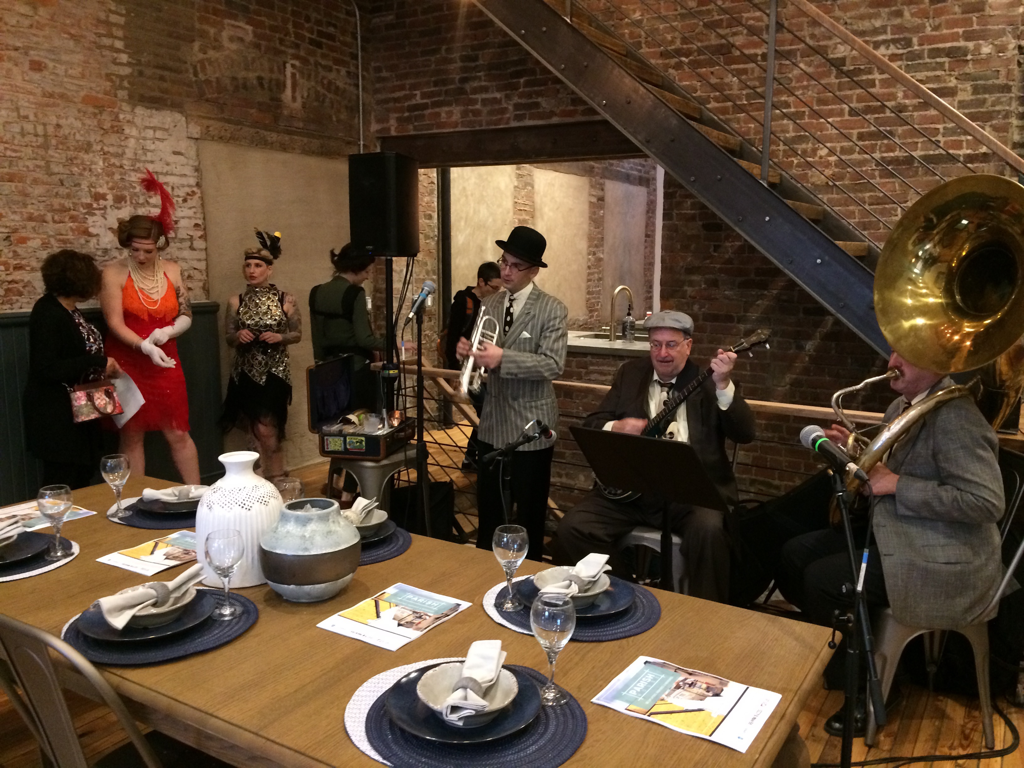 Drew Nugent and his band play while the Peek-A-Book Revue gets ready to start dancing the Charleston at a realtor's open house in East Kensington.