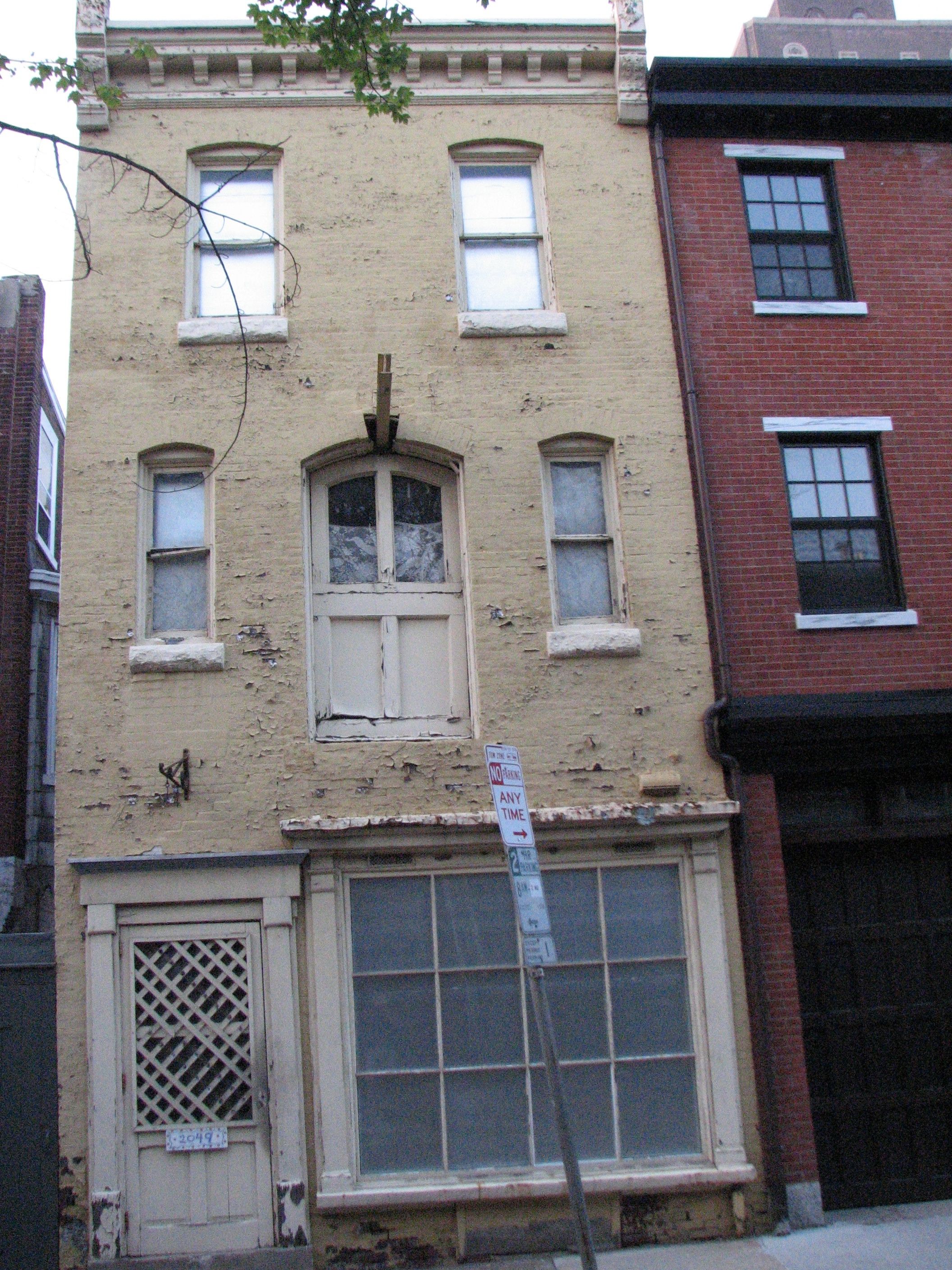 The building at 2049 began as a carriage house and became a storefront.